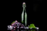 Wine Bottle With Red Grape Stock Photo