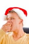 Christmas Hat Wearing Male Eating Apple Stock Photo