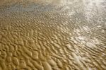 The Texture Of Wet Sea Sand With Patterns Of Water Stock Photo