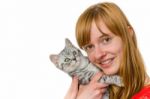 Teenage Girl Hugging Young Tabby Cat Stock Photo