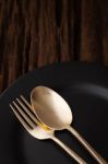 Black Empty Plate Fork Spoon On Wooden Table Background Stock Photo