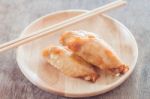 Grilled Chicken Wings On Wooden Plate Stock Photo