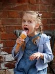 Girl Licking An Ice Cream Stock Photo