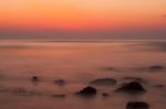 Soft Waves On A Rocky Beach In The Evening Stock Photo