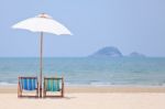 Beach Chairs And White Umbrella Stock Photo