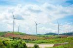 Windmills New Energy With Spring Flower On The Mountain Stock Photo