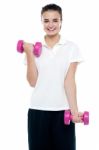 Smiling Fitness Teenage Girl Lifting Weights Stock Photo