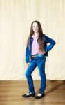 Little Girl With Long Hair In A Blue Denim Suit Stock Photo