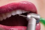 Dentist Curing A Female Patient Stock Photo