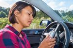 Young Woman Operates Electronic Route Planner In Car Stock Photo