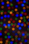 Colour Christmas Bokeh On A Dark Background Stock Photo