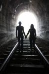 Couple Walking Together Through A Railway Tunnel Stock Photo