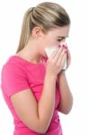 Young Girl Sneezing, Suffering From Cold Stock Photo