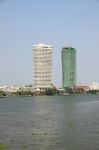 Construction And Completed Building On The River Bank Stock Photo