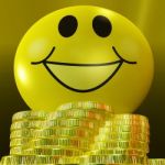 Smiley Face With Coins Showing Monetary Happiness Stock Photo