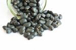 Black Beans In A Bottle On White Background Stock Photo