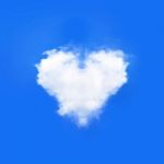 Blue Sky With Hearts Shape Clouds. Beauty Natural Background Stock Photo