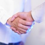 Handshaking Female Hands Stock Photo