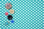 Buttons On Blue Polka Dot Fabric Background Stock Photo