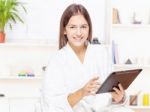 Girl In Bathrobe At Home With Touch Pad Stock Photo