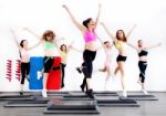 Group Of Women Doing Aerobics On Stepper Stock Photo