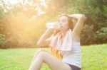 Asian Woman Are Drinking And Sitting On The Lawn Stock Photo