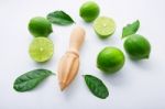 Fresh Limes And Wooden Juicer On White Background. Top View With Stock Photo