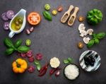 The Ingredients For Homemade Pizza On Dark Stone Background Stock Photo