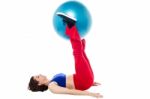 Fit Woman Holding Exercise Ball Between Legs Stock Photo