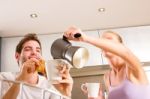 Couple In Kitchen Having Breakfast Stock Photo