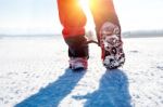 View Of Walking On Snow With Snow Shoes And Shoe Spikes In Winte Stock Photo