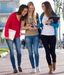 Students Having Fun With Smartphones After Class Stock Photo