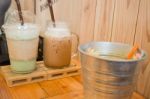 Glass Of Iced Drink On Wooden Table Stock Photo