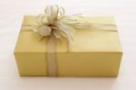 Gift Box With Ribbon Bow On Bed Stock Photo