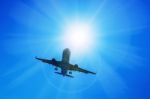 Airplane And Sunbeam With Lens Flare Effect On Blue Sky Backgrou Stock Photo