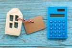 Wood House With Calculator And Blank Label Stock Photo