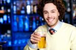 Smiling Young Man Holding A Glass Of Beer Stock Photo