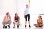 Group Of Diverse People Looking Woman Lifting Kettlebell In Gym Stock Photo