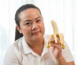 Fat Woman With Banana Stock Photo