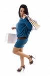 Side Pose Of Smiling Model Holding Carry Bags Stock Photo