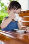 Little Asian Girl (thai) Drinking From A Cup Stock Photo