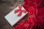 Valentine Gift Box On Wood Table With Red Roses Bouquet For Love And Happiness Theme Stock Photo