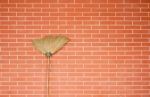 Broom Stick On Brick Wall Stock Photo