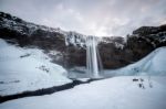 View Of Seljalandfoss Waterfall In Winter Stock Photo