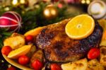 Christmas Baked Duck Served With Potatoes, Orange And Tomatoes Stock Photo