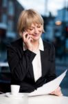 Manager Communicating Via Cell Phone In Cafe Stock Photo