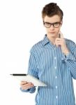 Boy Thinking By Holding Tablet Pc Stock Photo