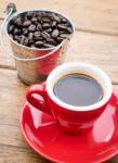 Red Cup Of Espresso On Wooden Table Stock Photo