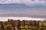 Lake Behind Foothills Of Tatra Mountains. Village On Lakeside Stock Photo