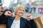 Joyful Businesswoman Holding Shopping Bags Stock Photo